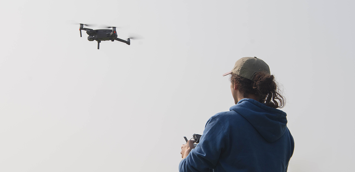 Field investigator piloting a drone