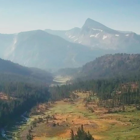 Valley beneath mountain peaks
