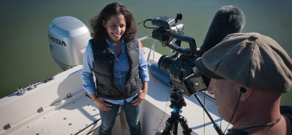 Sejal being interviewed by a reporter on the Baykeeper boat