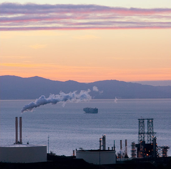 Refinery at sunset with Bay in the background