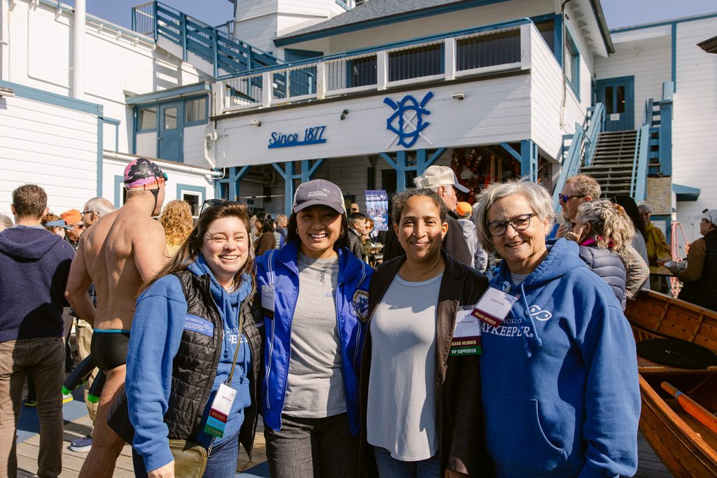 Four people smiling outside at the Dolphin Club in SF