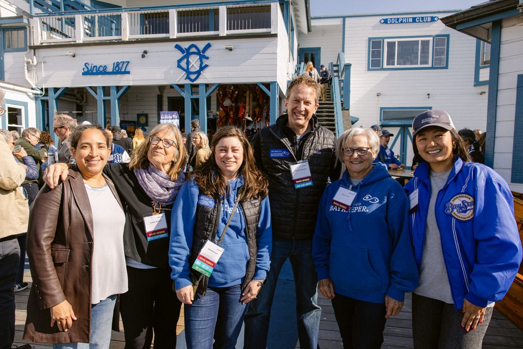Group of guests at the Bay Celebration outside at the Dolphin Club