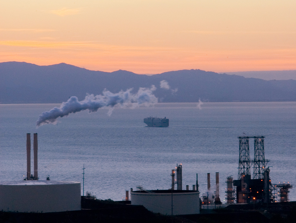Oil Refinery with Bay in the background at sunset