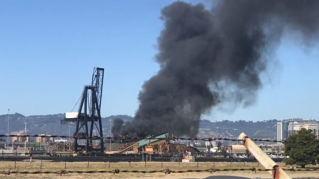 Plume of dark smoke above equipment at the Schnitzer/Radius facility in Oakland
