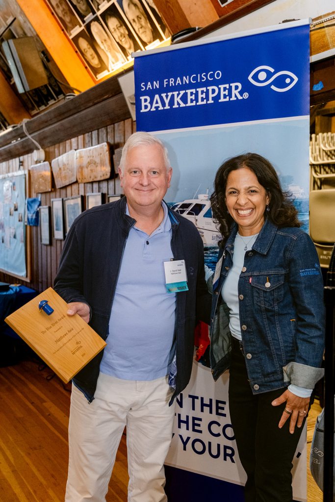 Two people holding an award plaque