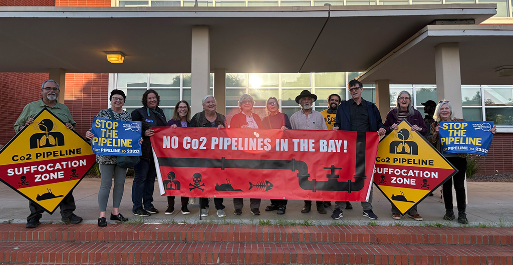 Group of people holding sign reading: No CO2 Pipelines in the Bay!