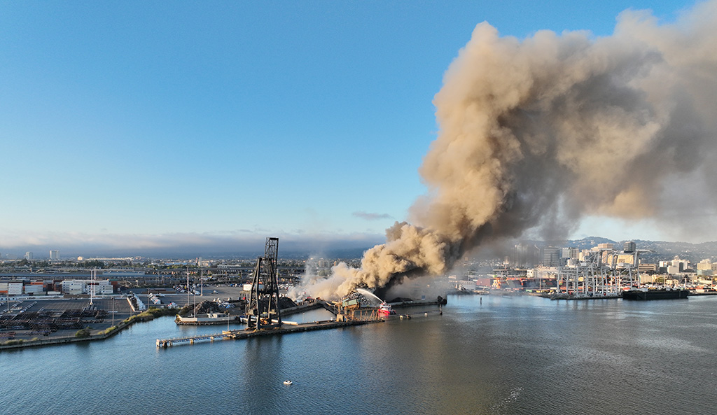 Schnitzer Steel on fire with a plume of smoke