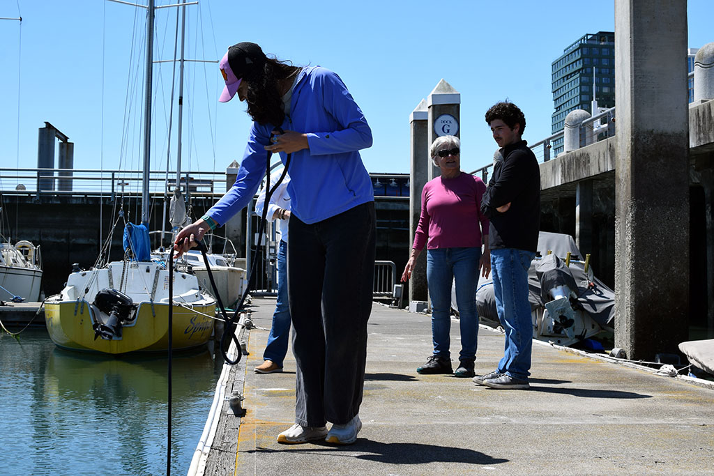 Baykeeper volunteer lowering a sampling device into the Bay